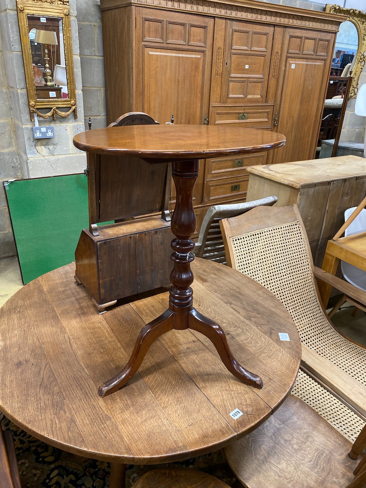 A Victorian mahogany oval tilt top tripod wine table, width 54cm, depth 30cm, height 69cm